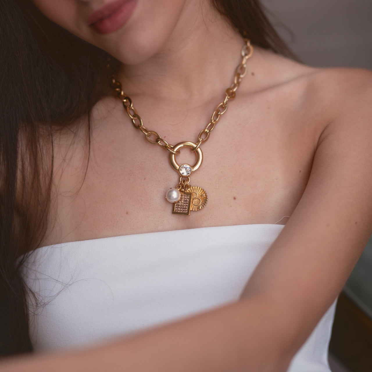 A photo of a woman wearing a Meridian necklace