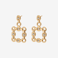 Gold chain-link earrings with diamond-like stones on a light gray background