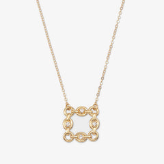 Gold necklace with a square pendant on a light beige background