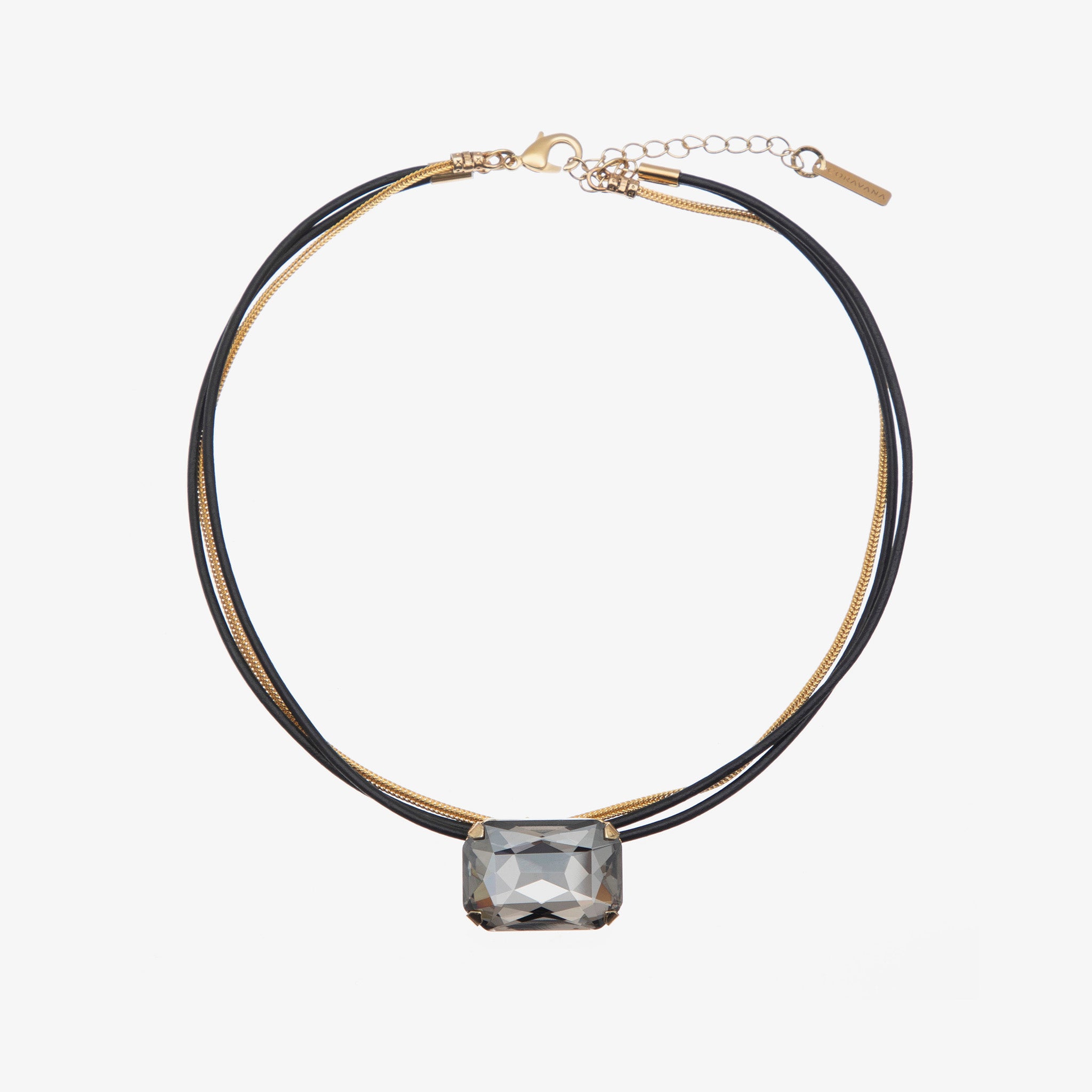 A choker necklace with a gold chain and silver leather layers, featuring an octagon-shaped pink crystal centerpiece.