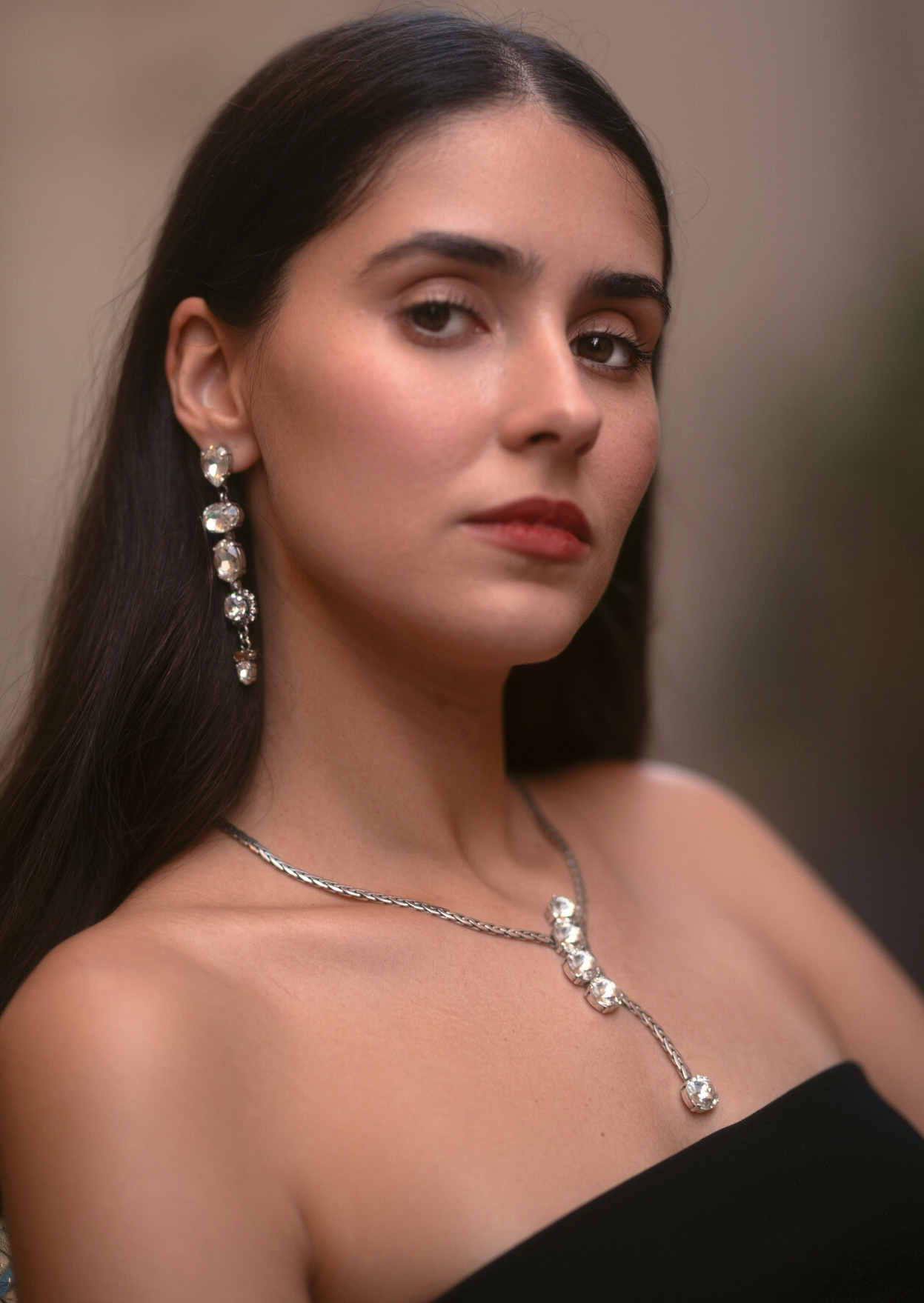 a photo of a woman wearing coravana's jewelry set