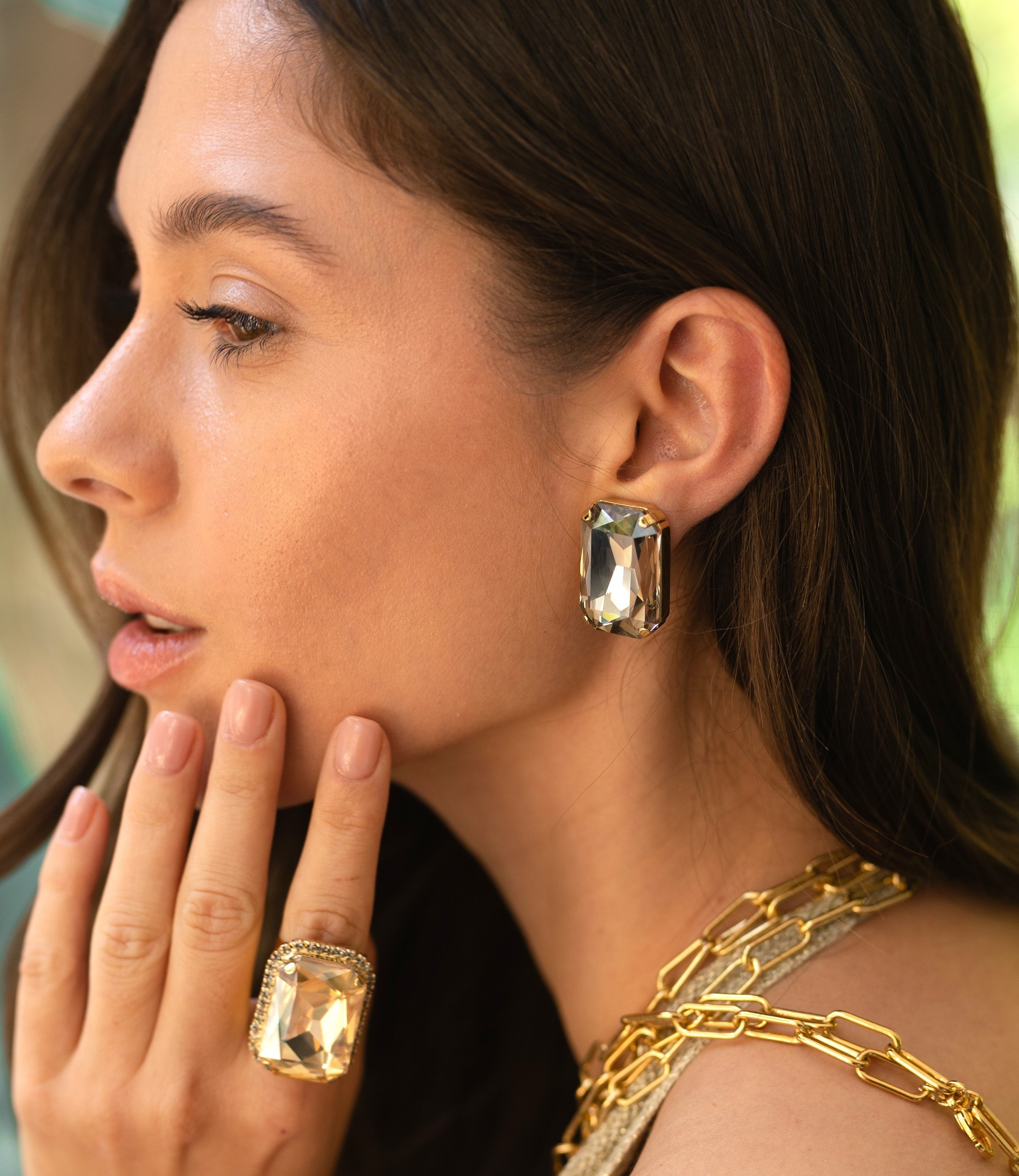 A woman wearing Stardust Earrings and crystal ring
