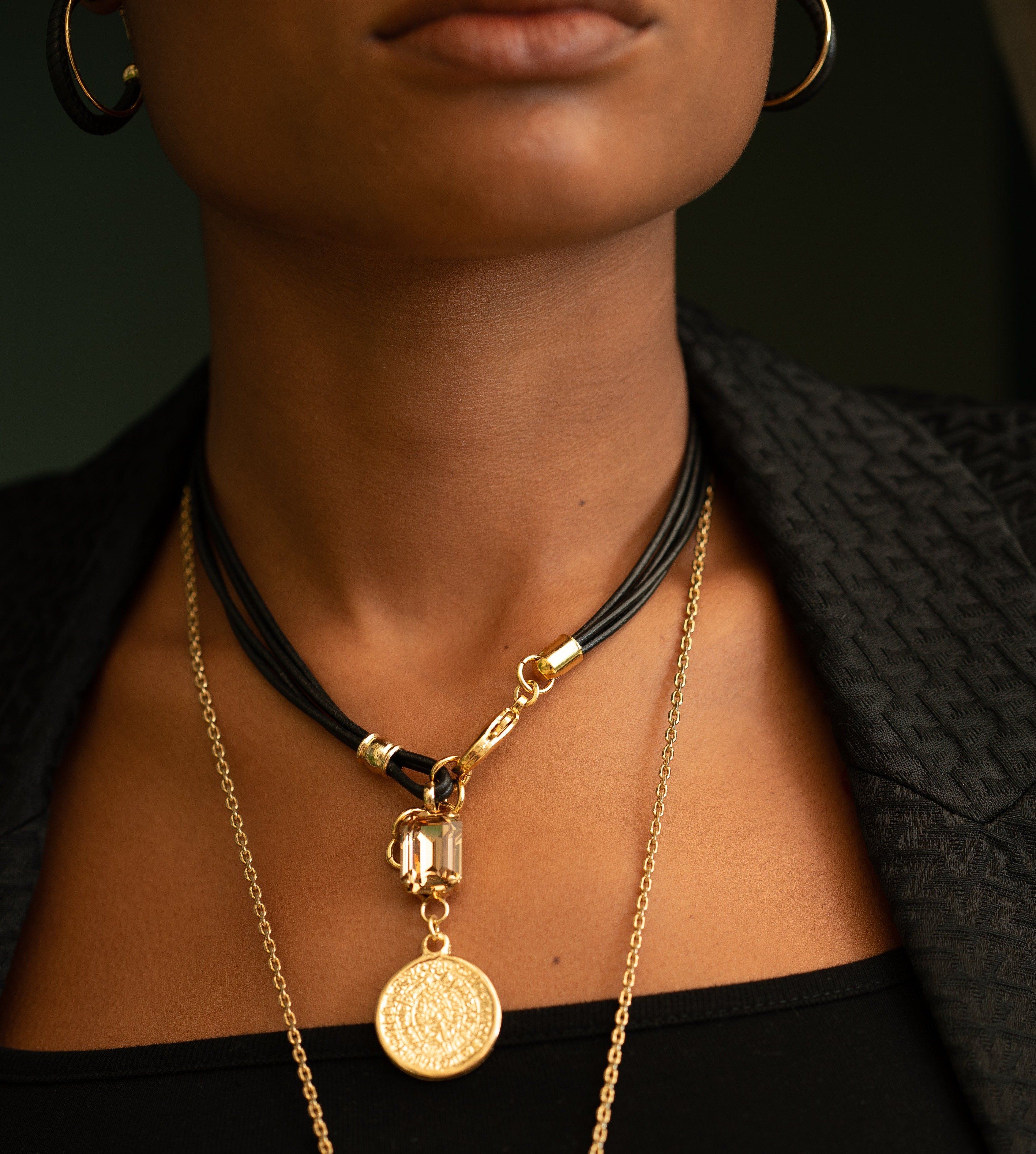 photo of a woman wearing a multilayer Medallion Charm Necklace
