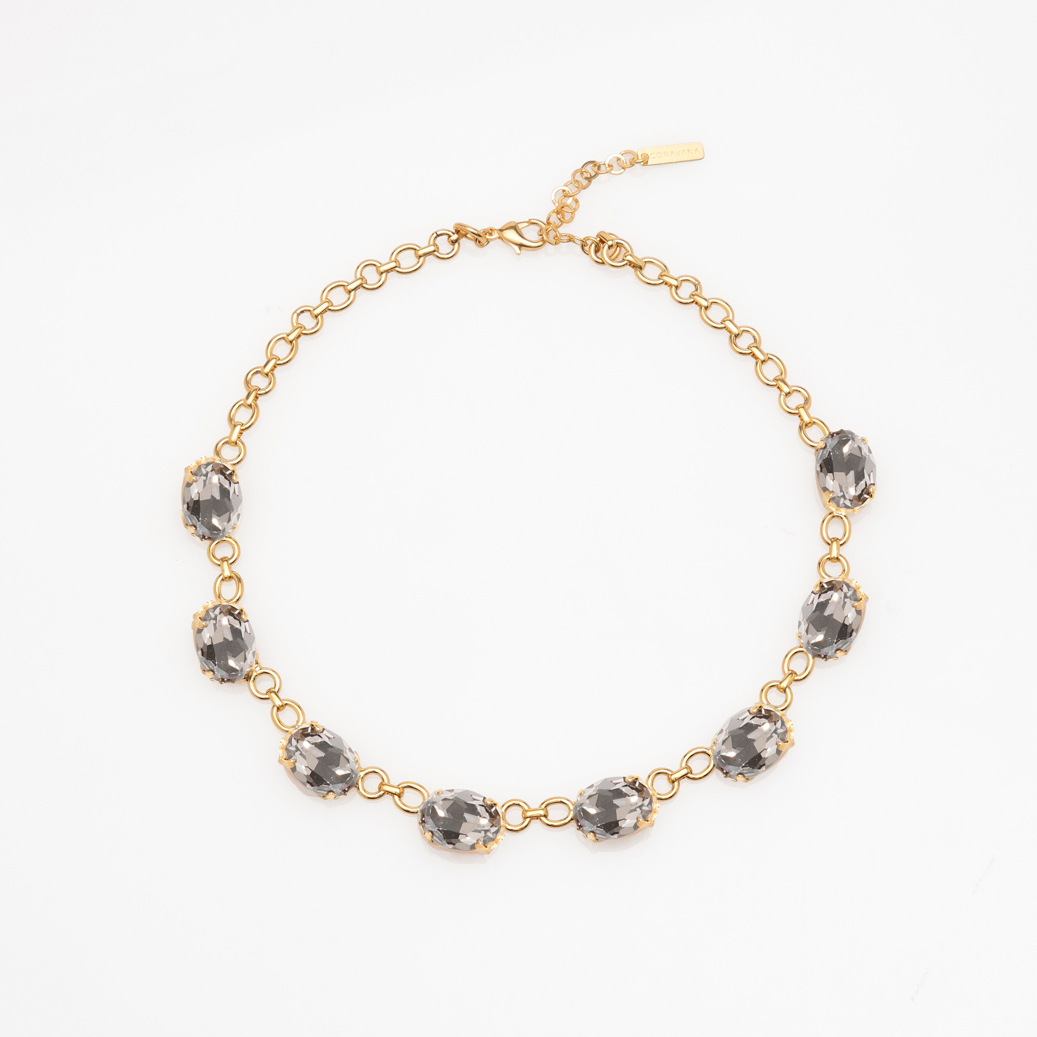 Gold bracelet with gray gemstones on a white background