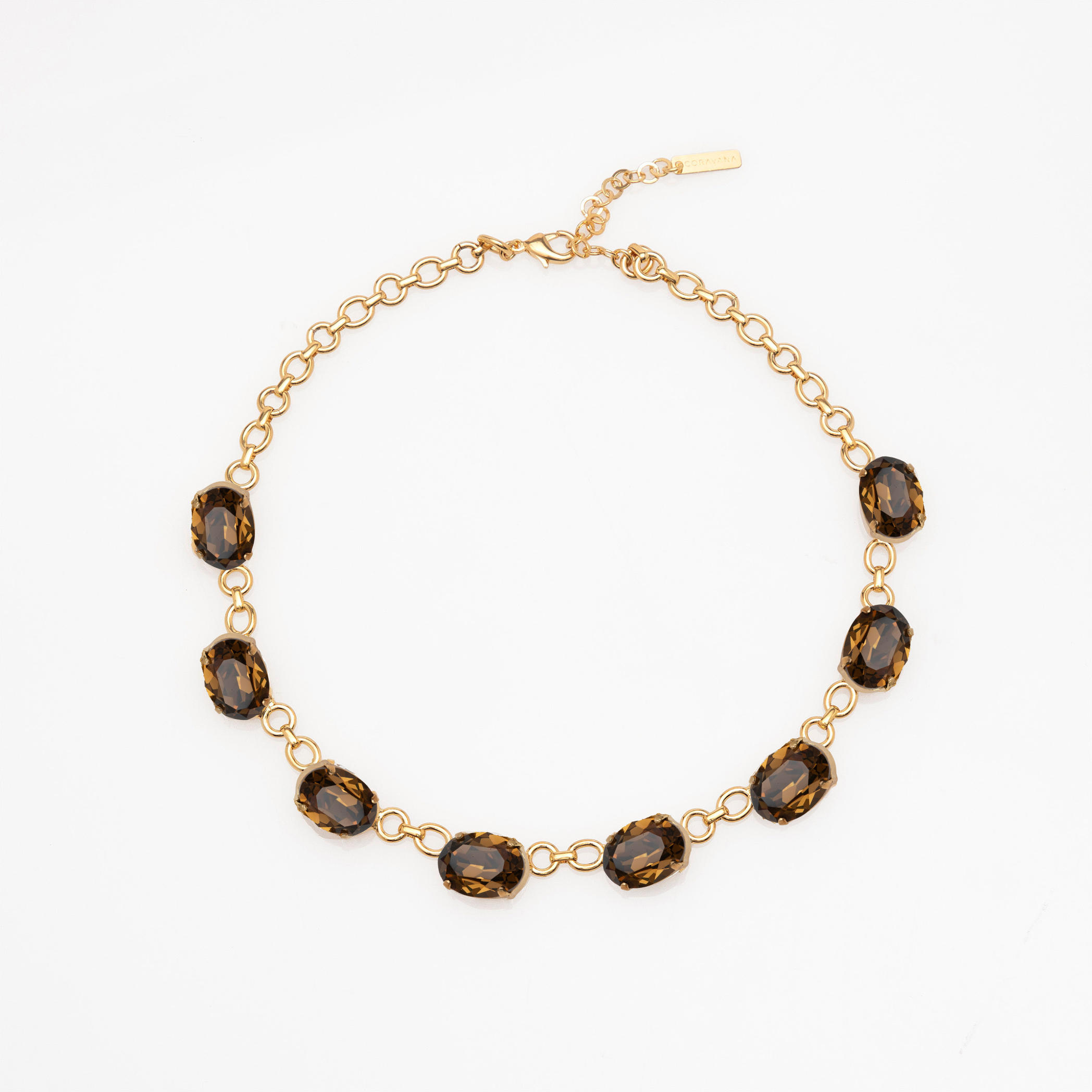 Gold necklace with brown gemstones on a white background