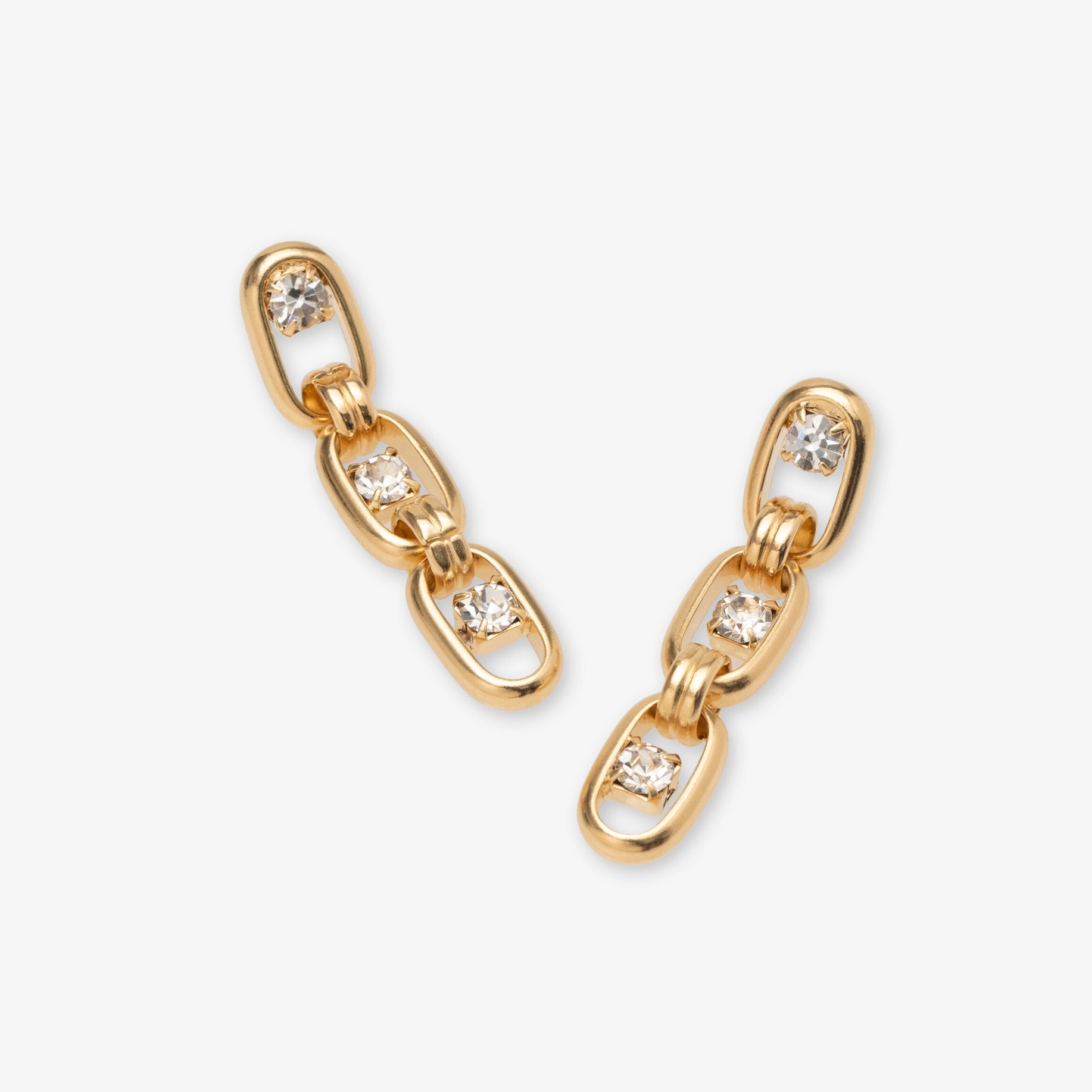 Gold chain earrings with embedded diamonds on a white background