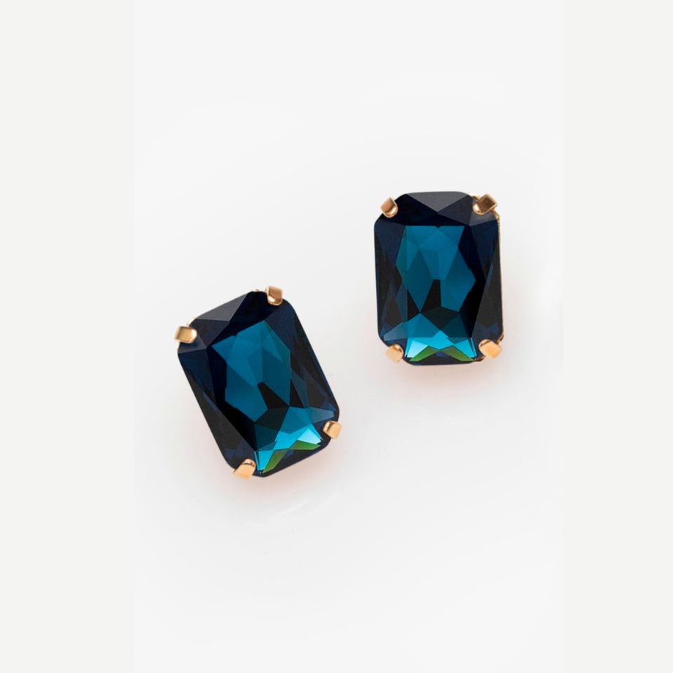 Pair of blue gemstone earrings on a white background