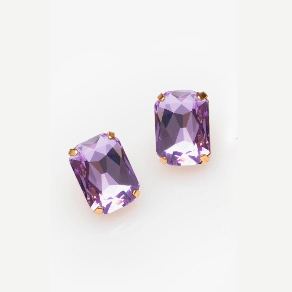 Pair of purple gemstones with gold prongs on a white background