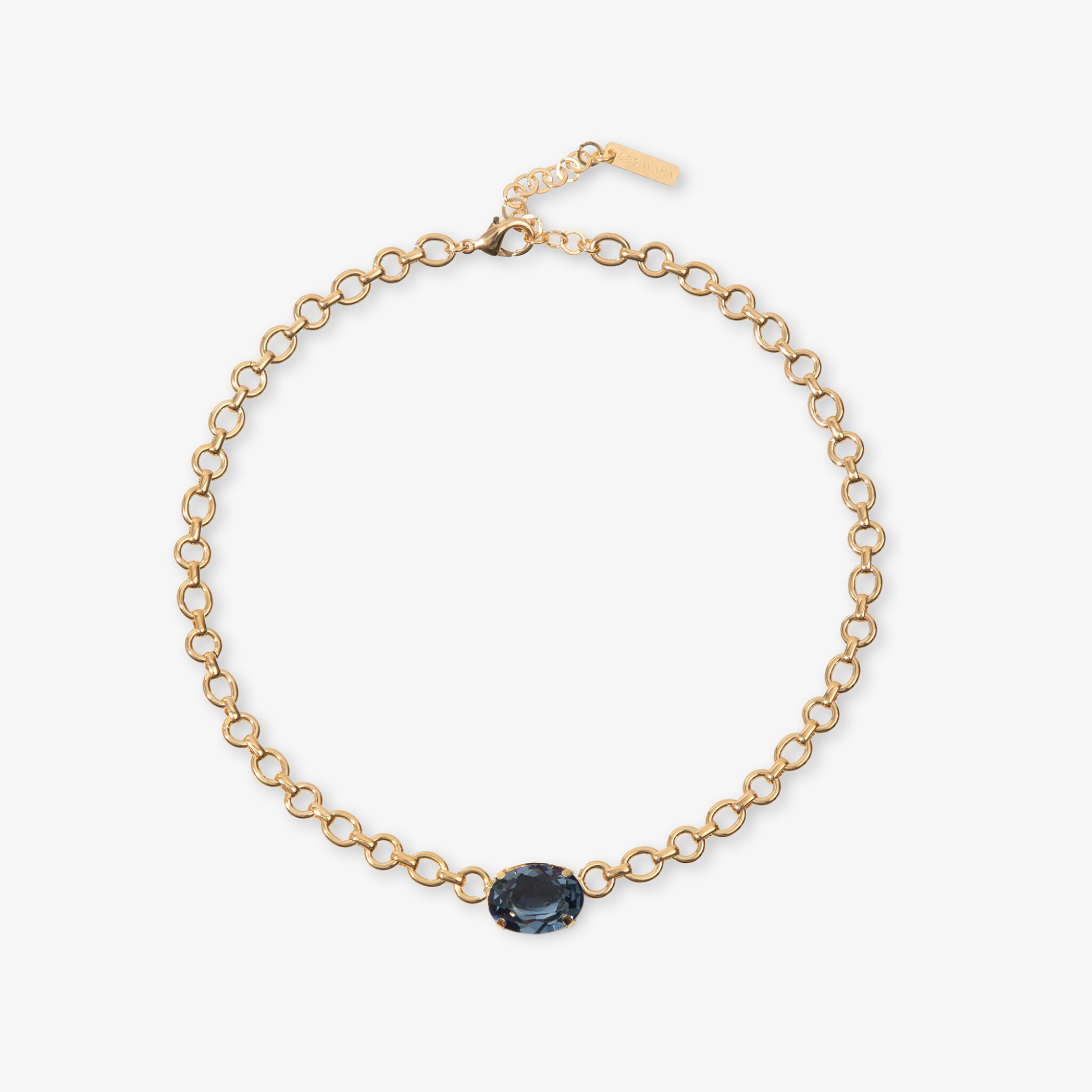 Gold bracelet with a blue gemstone on a white background