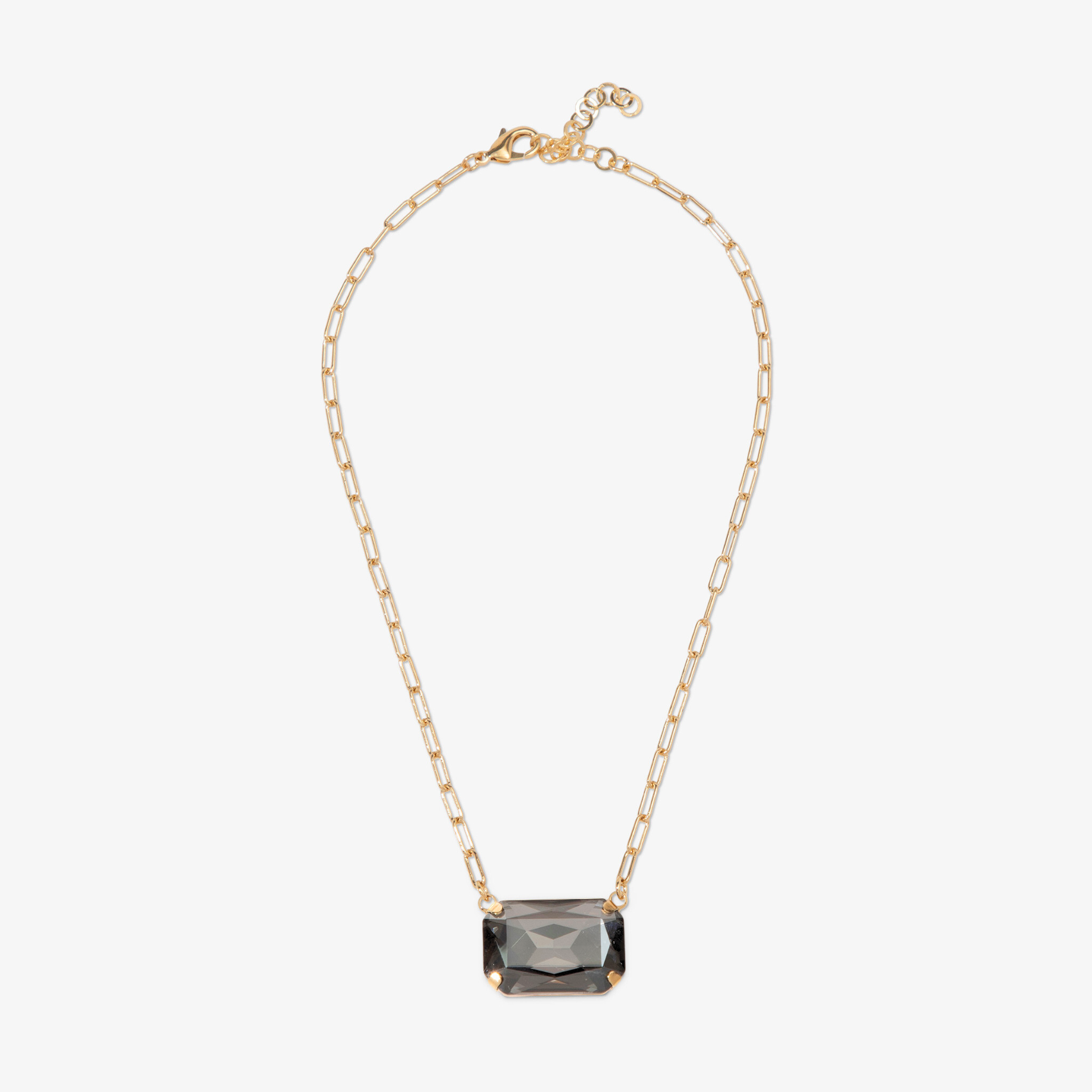 Gold necklace with a rectangular gemstone pendant on a white background