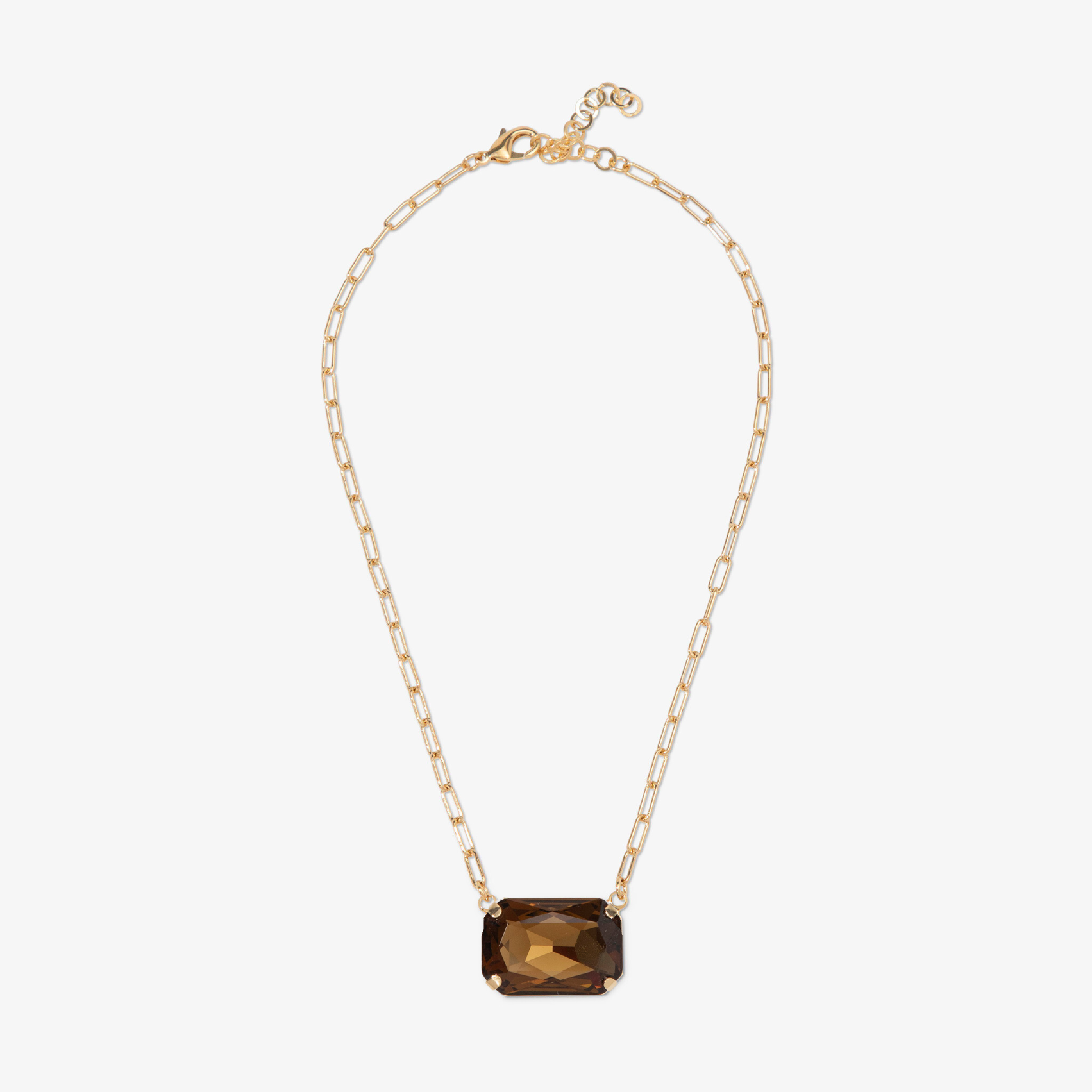 Gold necklace with a brown gemstone on a white background
