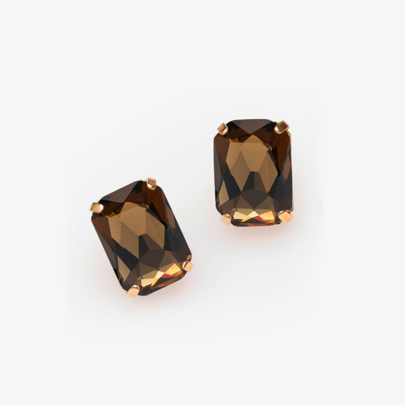 Pair of smoky brown gemstone earrings on a white background
