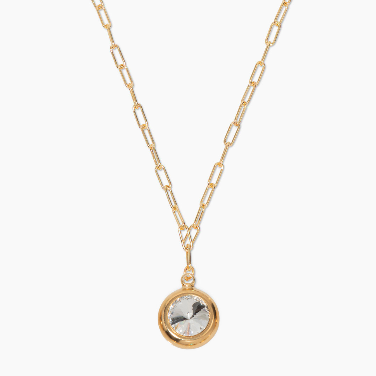 Gold chain necklace with a round pendant on a white background