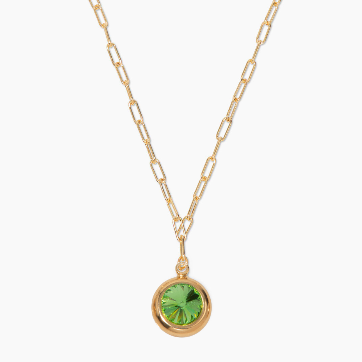 Gold necklace with a green pendant on a white background