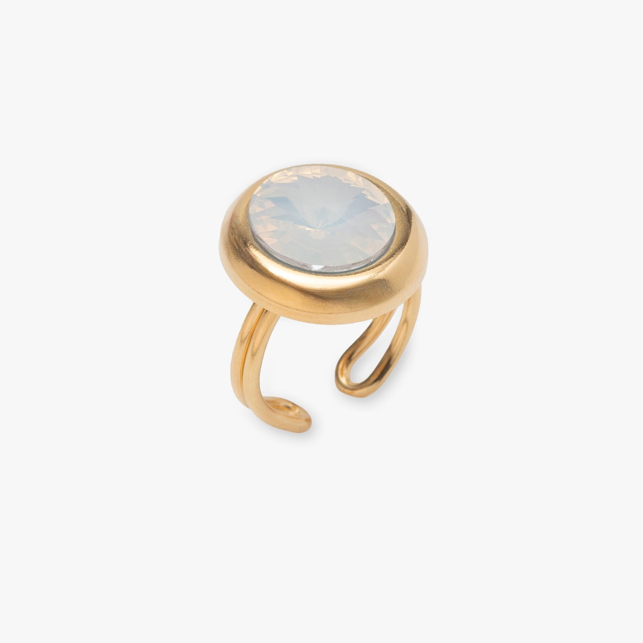 Gold ring with a light-colored stone on a white background