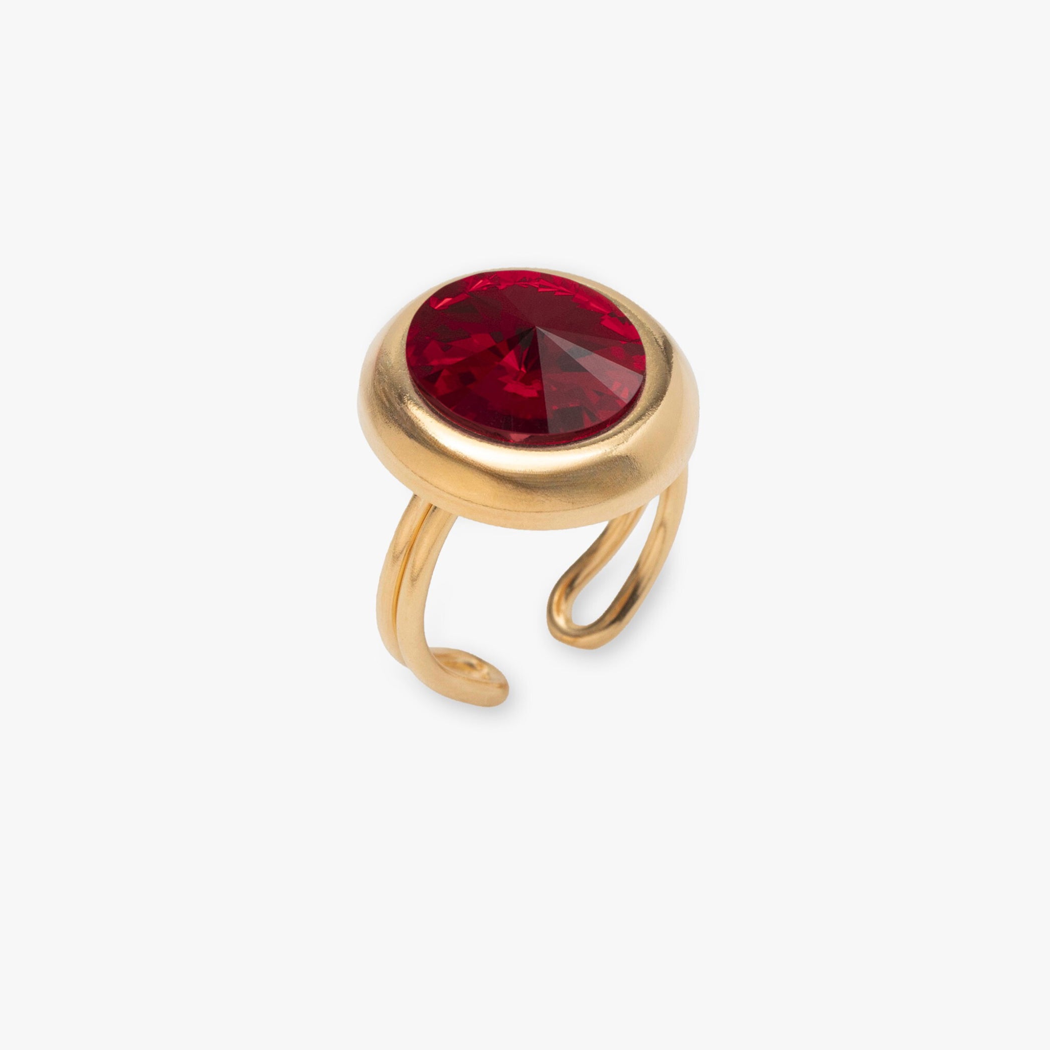 Gold ring with a red gemstone on a white background