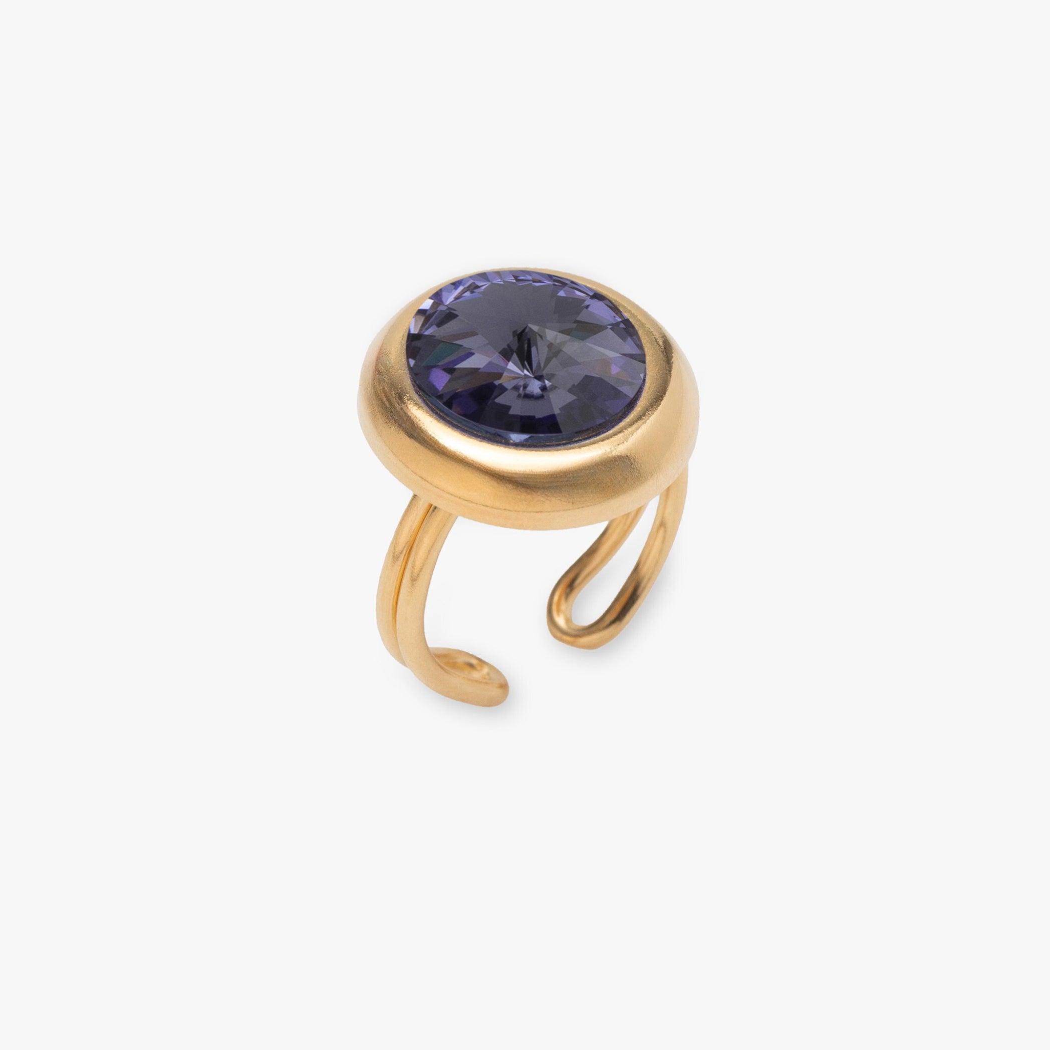 Gold ring with a purple gemstone on a white background