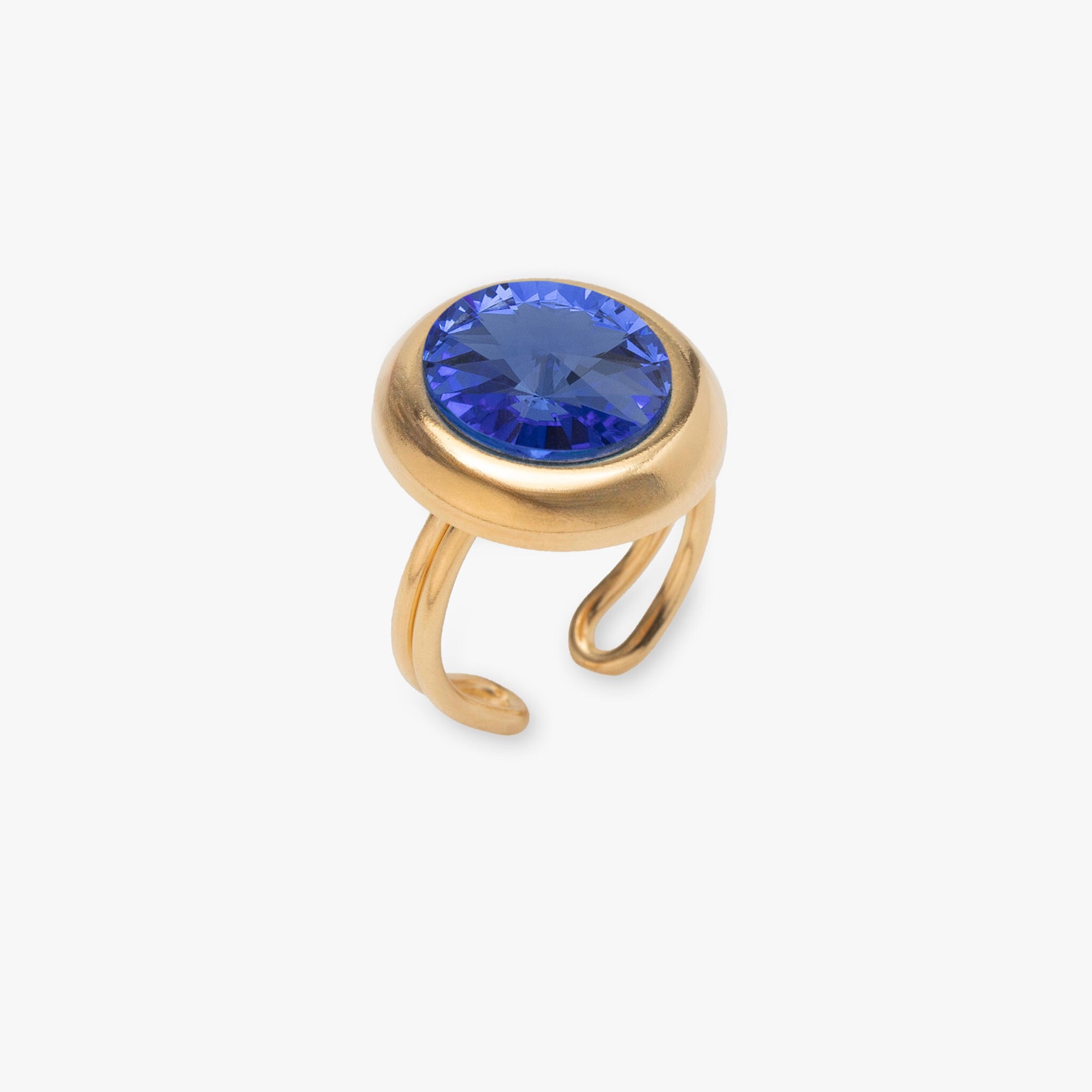 Gold ring with a blue gemstone on a white background