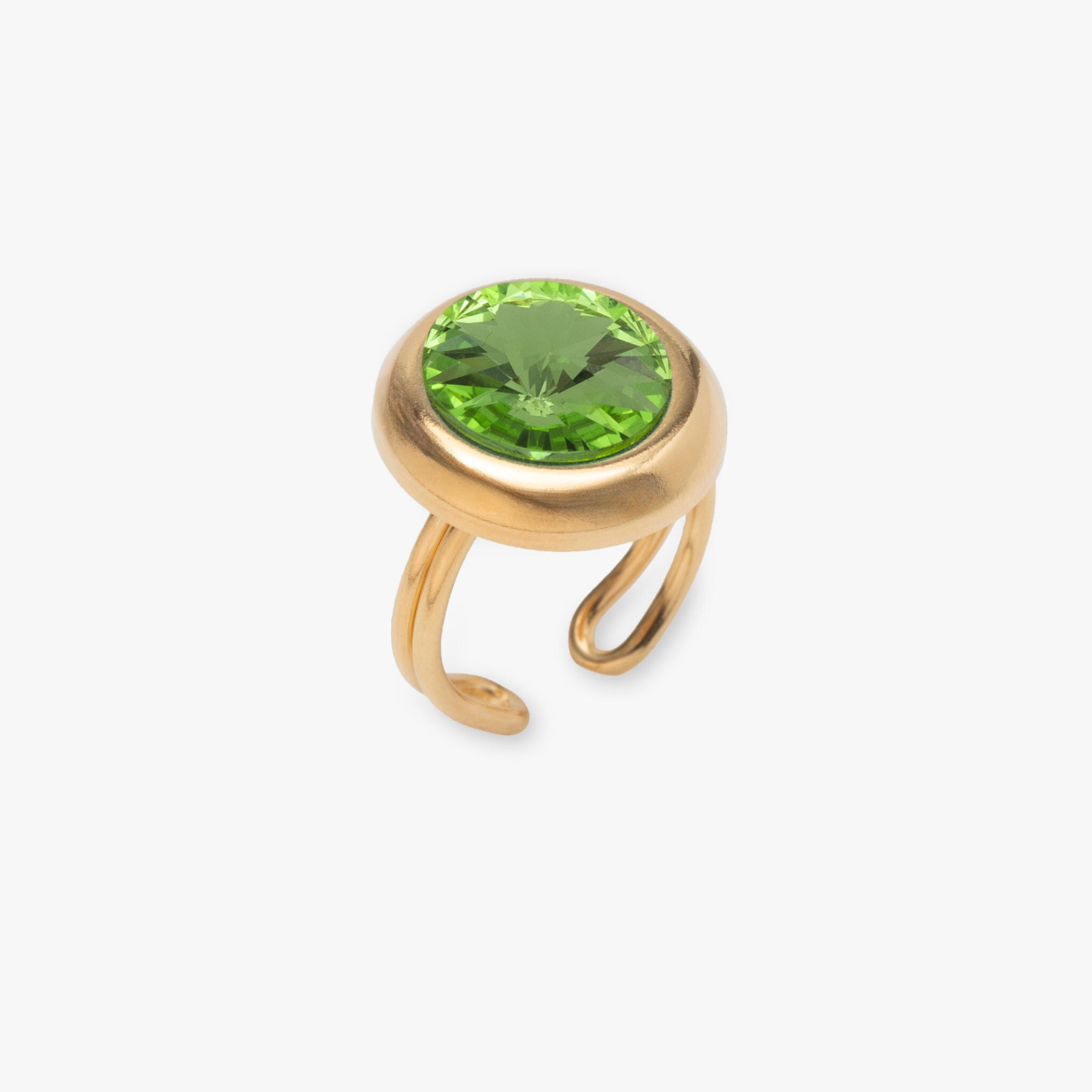 Gold ring with a green gemstone on a white background