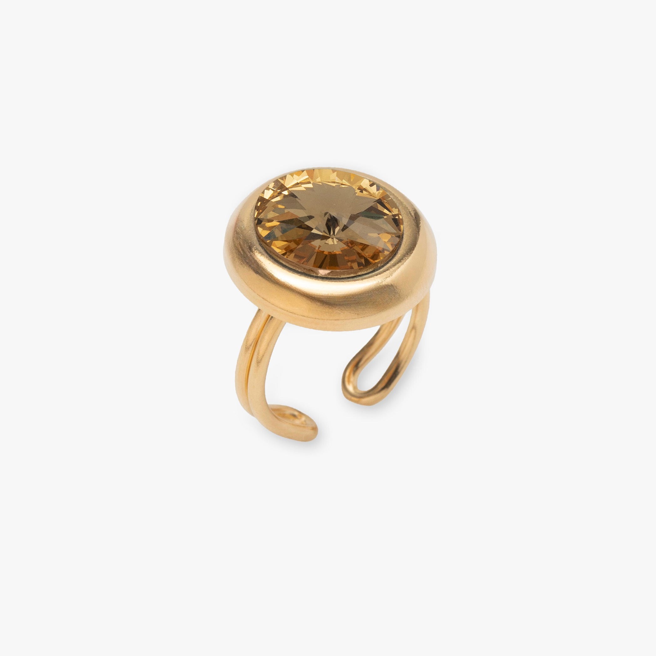 Gold ring with a brown gemstone on a white background