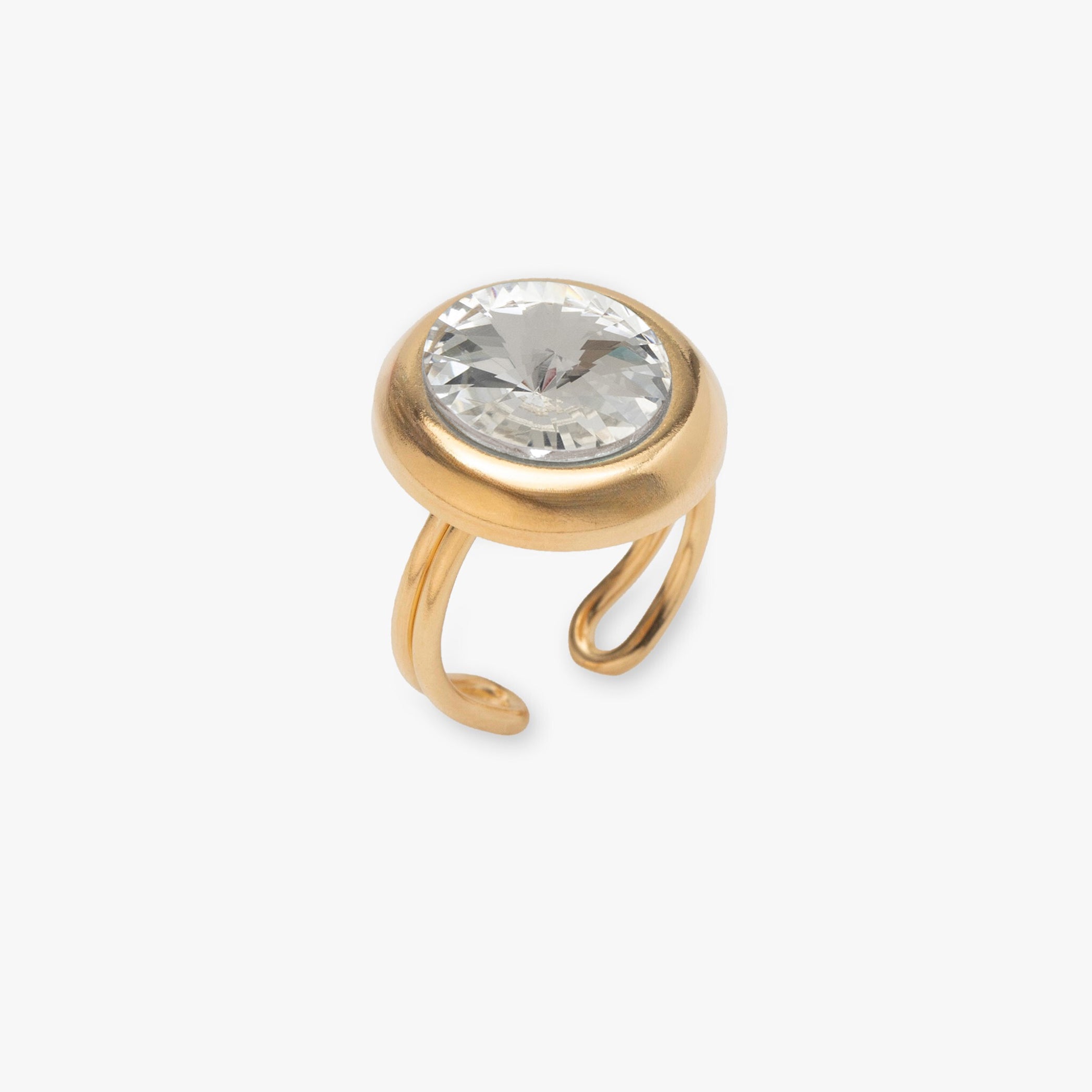 Gold ring with a clear gemstone on a white background