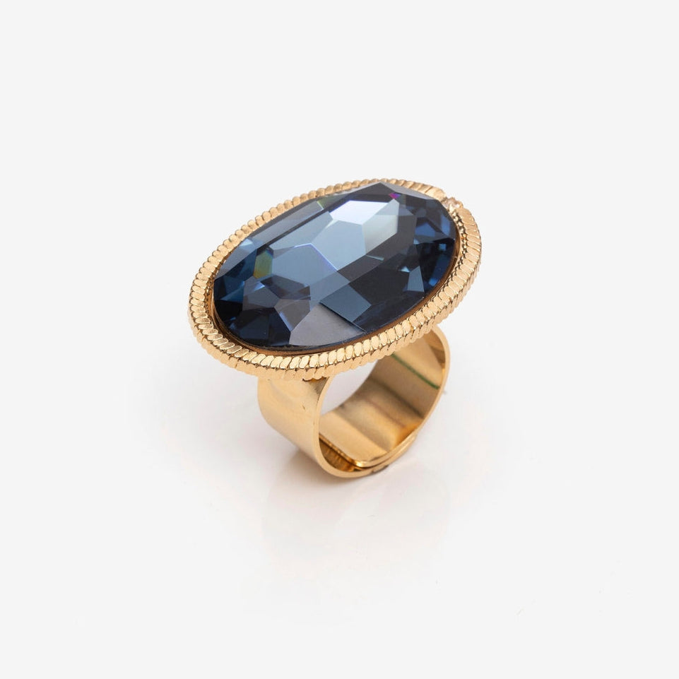 Gold ring with a large blue gemstone on a white background