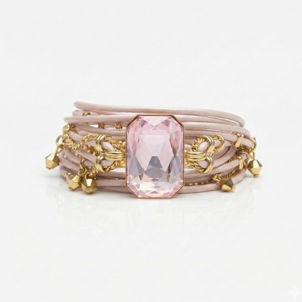 Pink bracelet with a large gemstone and gold accents on a white background