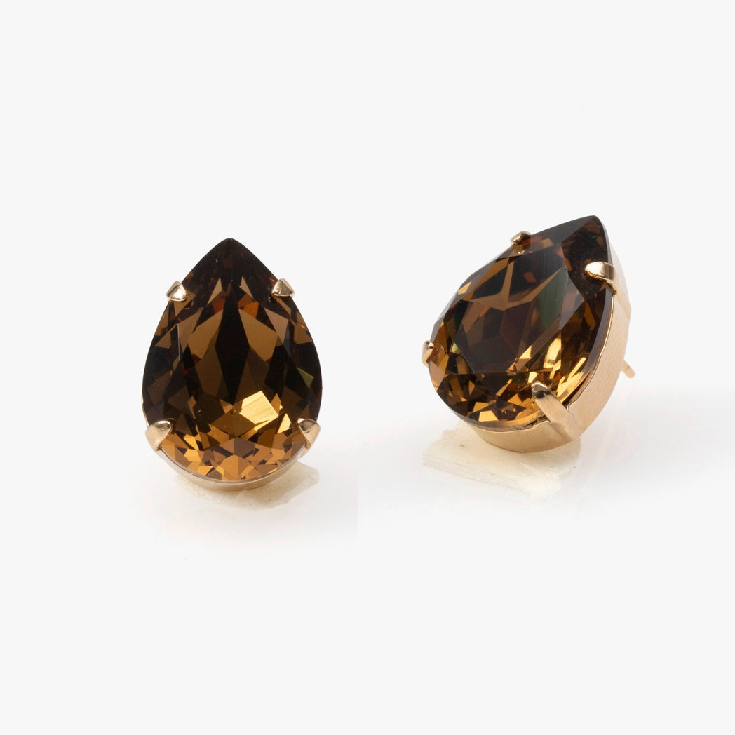 Pair of gold earrings with teardrop-shaped brown gemstones on a white background