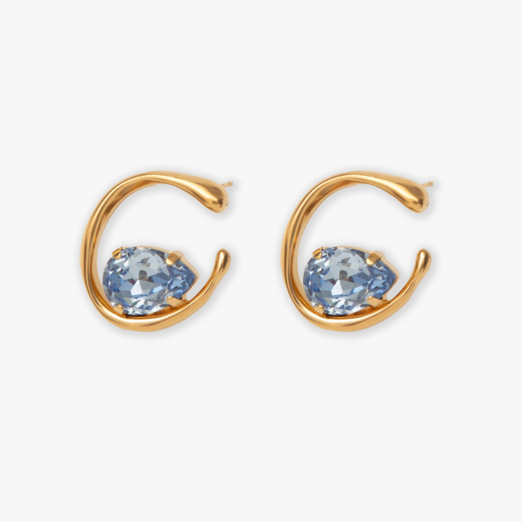 A pair of gold-colored moondrop earrings with crystal centers, designed to be elegant and simple yet striking.