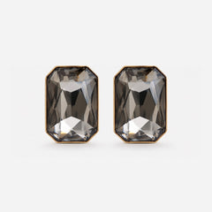 A pair of rectangular faceted smoky gray gemstone stud earrings with gold-toned metal borders, shown on a light gray background.