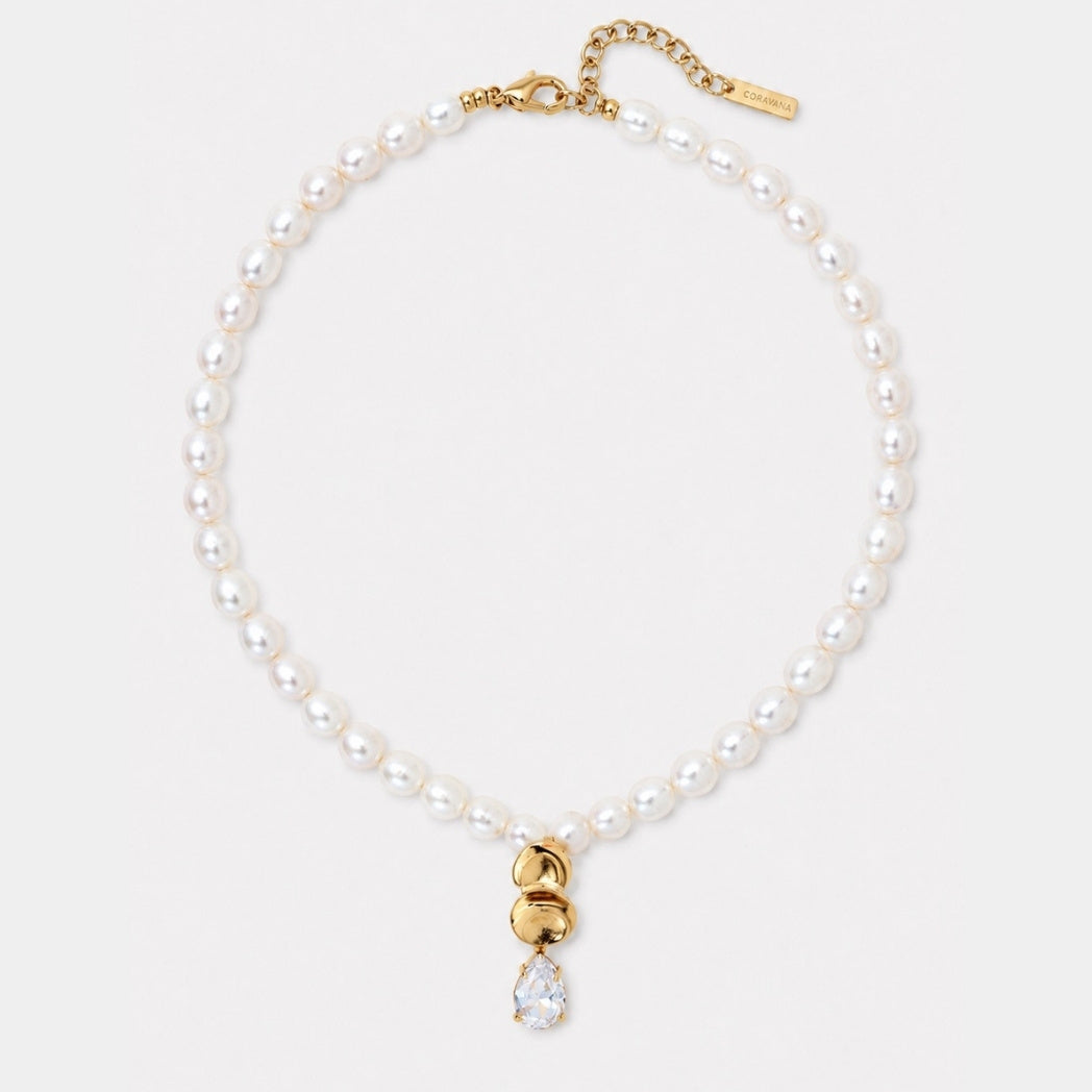 Pearl necklace with a gold clasp on a white background