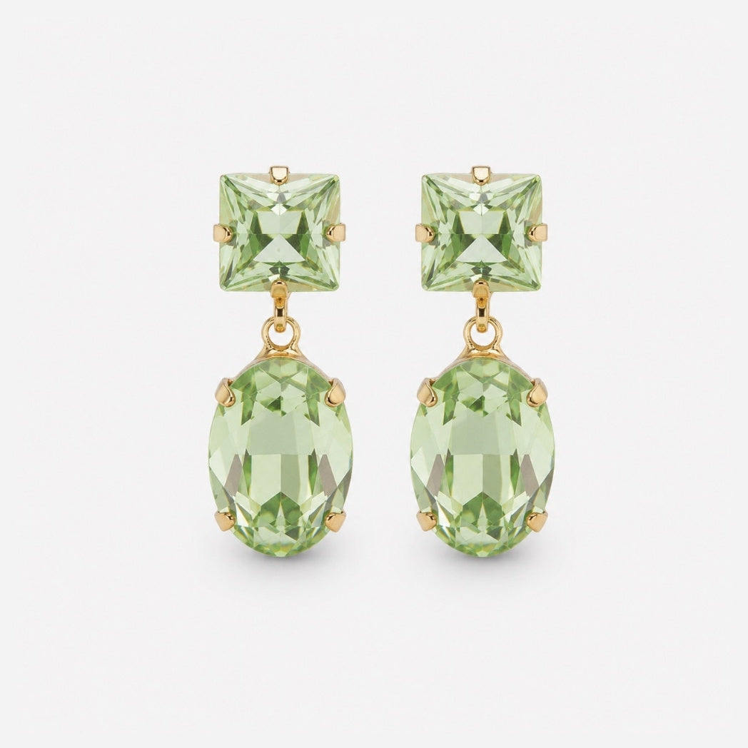 A pair of gold drop earrings featuring square-cut light green gemstones on the studs and larger oval-cut light green gemstones hanging below, set against a plain light gray background.