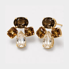 A pair of gold-toned drop earrings featuring a dark brown oval stone, two smaller brown rectangular stones, and a clear teardrop-shaped crystal, displayed on a light gray background.
