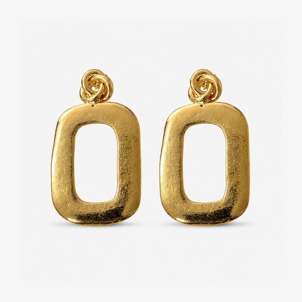 Gold hoop earrings on a light gray background