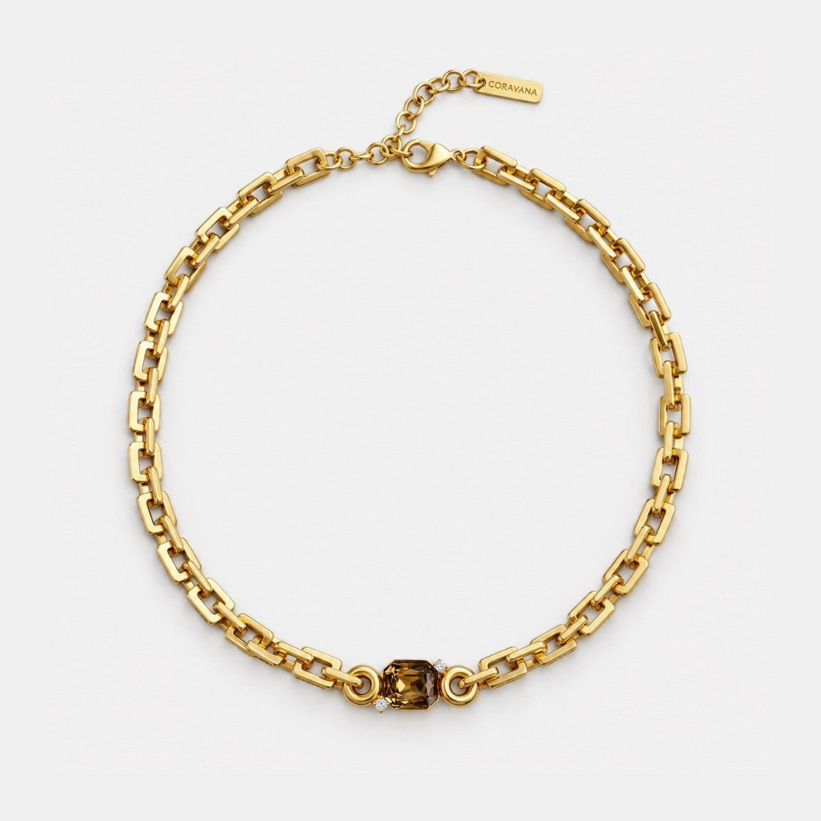A gold chain necklace with a central faceted brown gemstone, displayed on a clean white background. A small gold tag on the clasp is engraved with the brand name 'SARABINO'.
