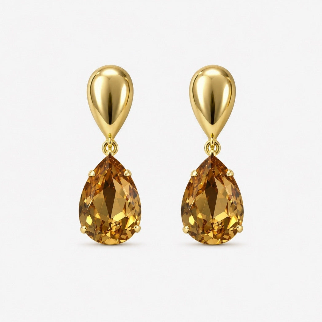 Gold earrings with teardrop-shaped brown gemstones on a white background
