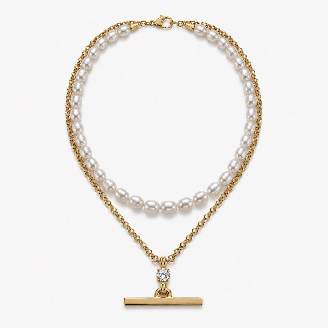 Two pearl necklaces with gold chains on a white background