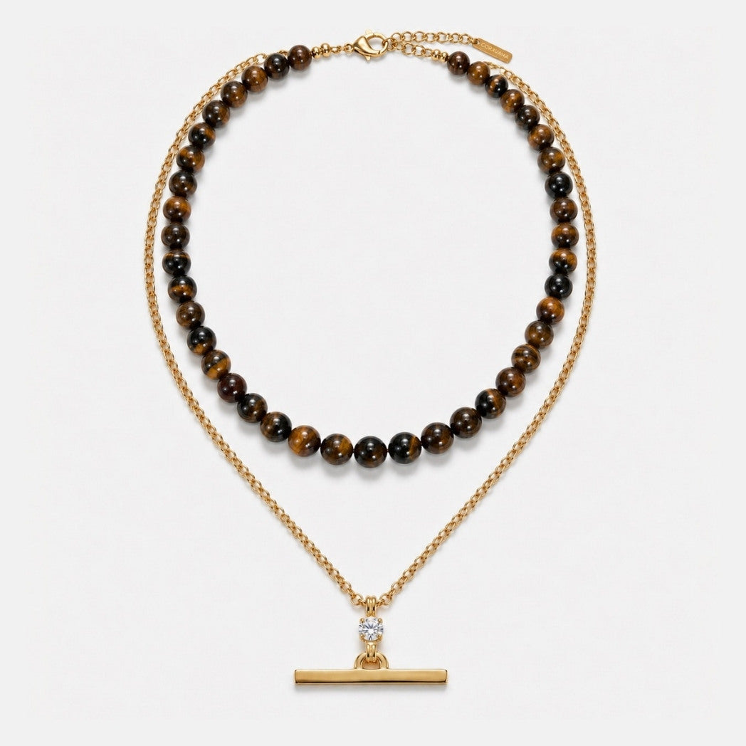 Two necklaces on a white background, one with brown beads and the other with a gold clasp.