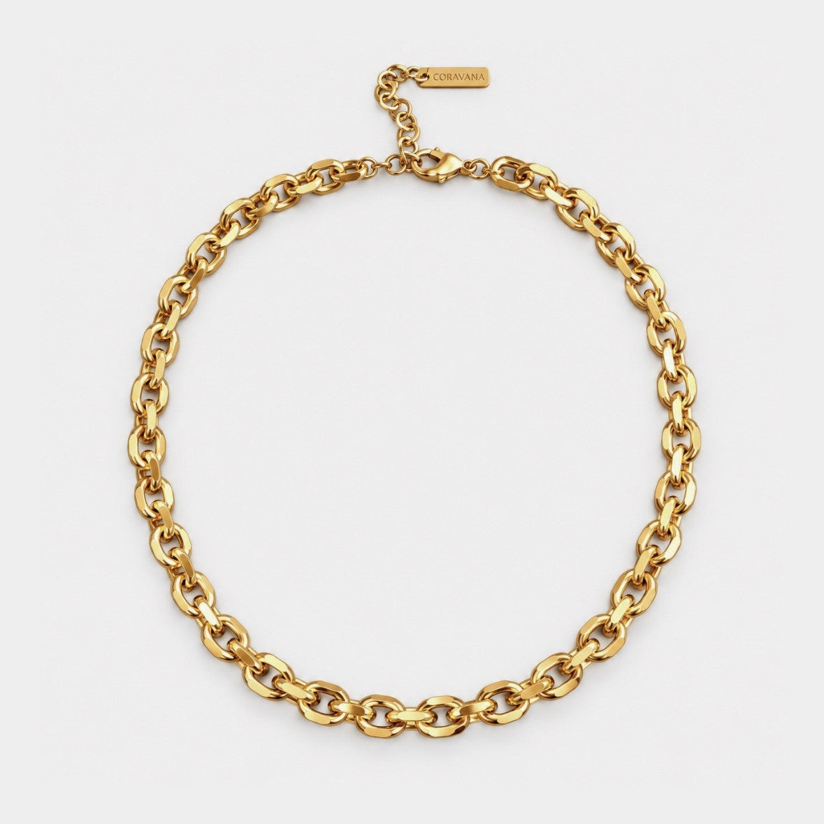 A gold chain choker necklace with a matching extender chain and a small rectangular brand tag engraved with 'MCKINNEY', displayed on a clean white background.