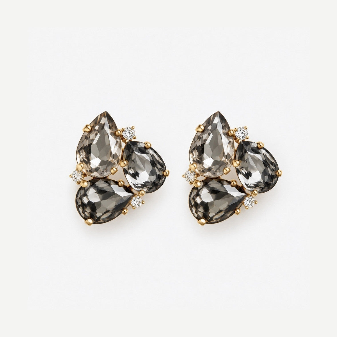 A pair of gold-toned cluster earrings featuring faceted teardrop-shaped smoky gray gemstones and small clear accent stones, displayed on a clean white background.