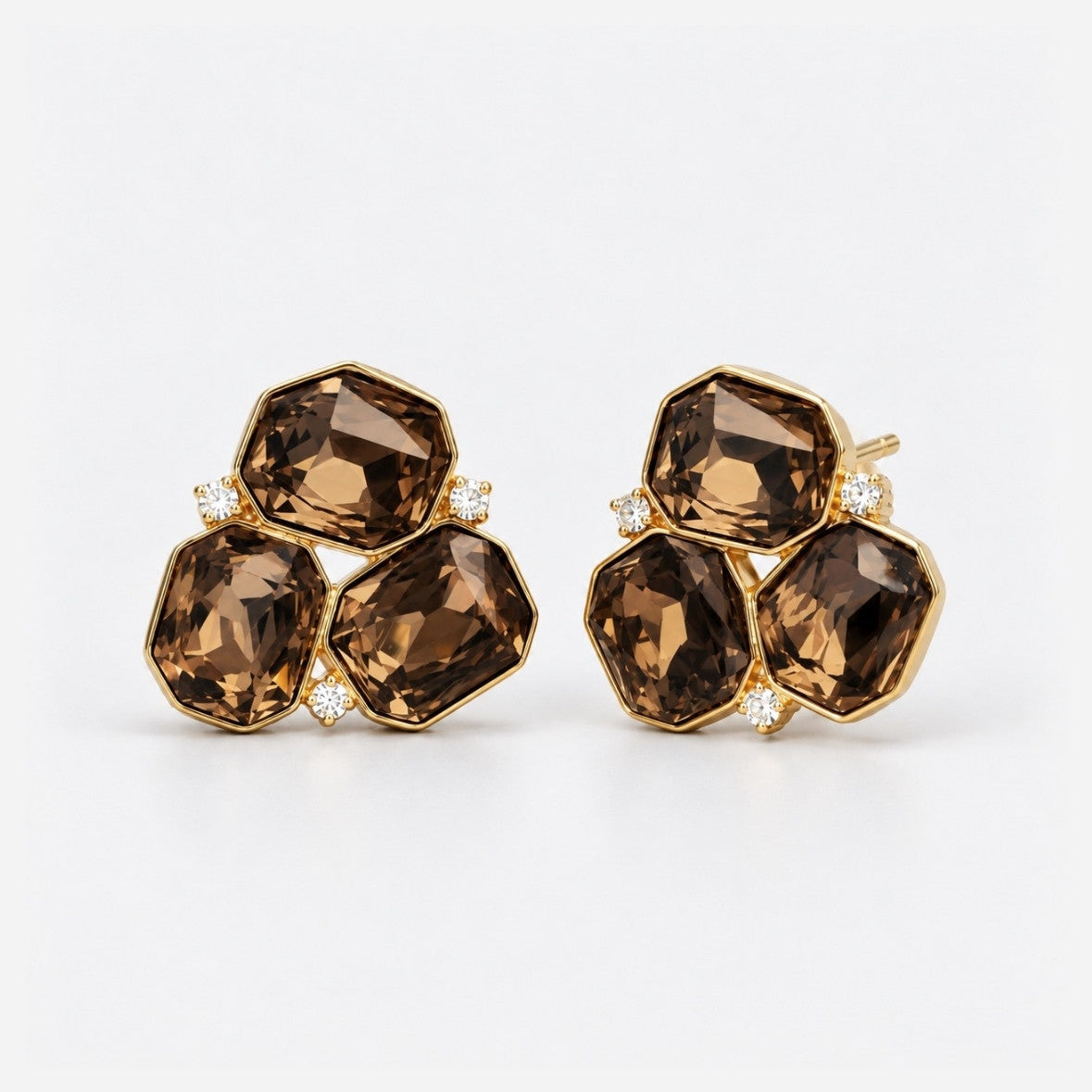 A pair of gold-toned cluster stud earrings featuring three faceted brown smoky gemstones and small clear accent stones, set against a clean white background.