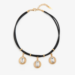 Necklace with black cord, gold accents, and crystal pendants on a white background