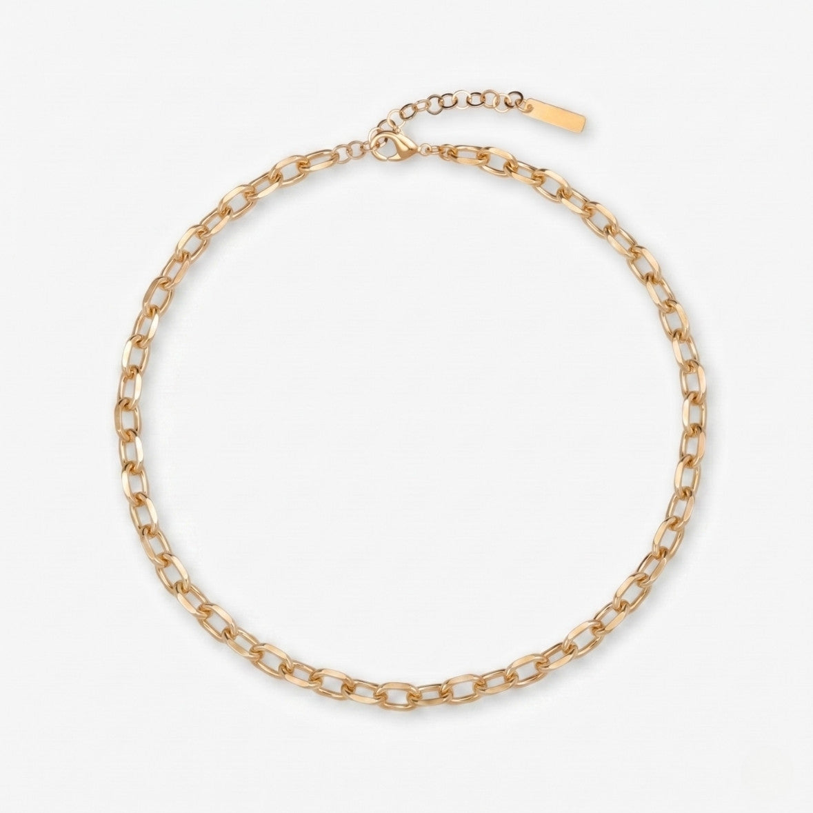 Gold chain necklace on a light gray background