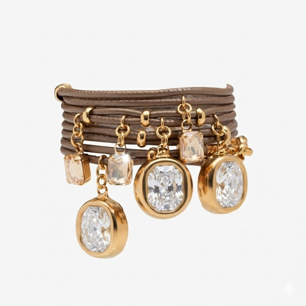 Set of gold-rimmed earrings with crystal pendants on a beige background