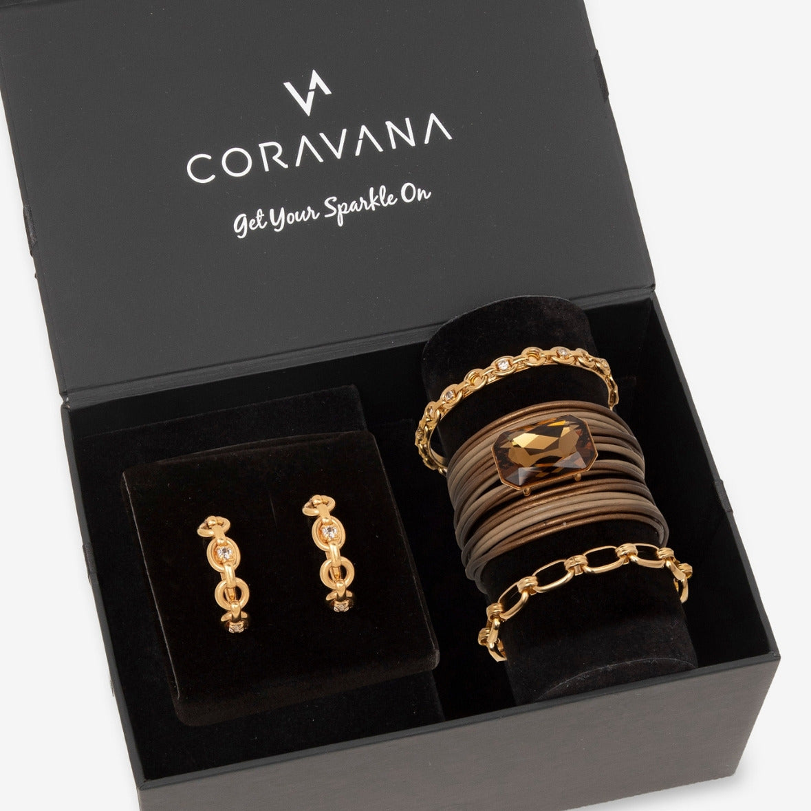 Jewelry set including earrings and bracelets in a Coravana box.