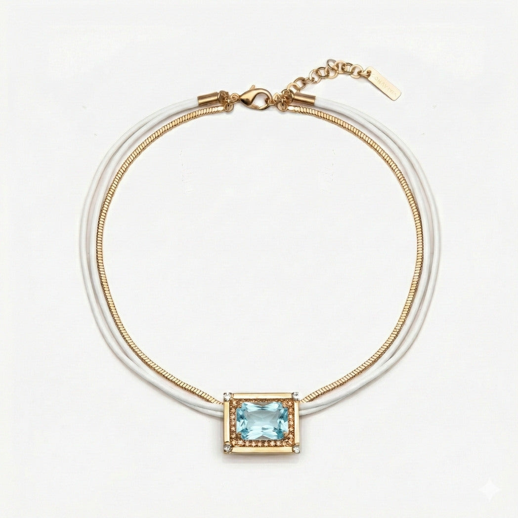Gold bracelet with a blue gemstone on a white background