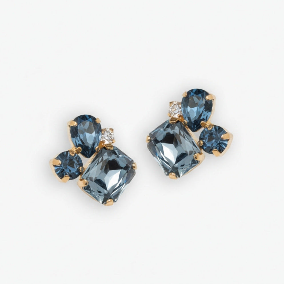 Pair of earrings with blue gemstones on a white background