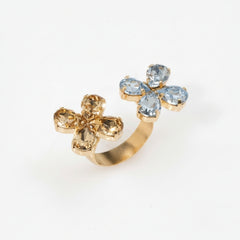 Gold ring with blue gemstones on a white background