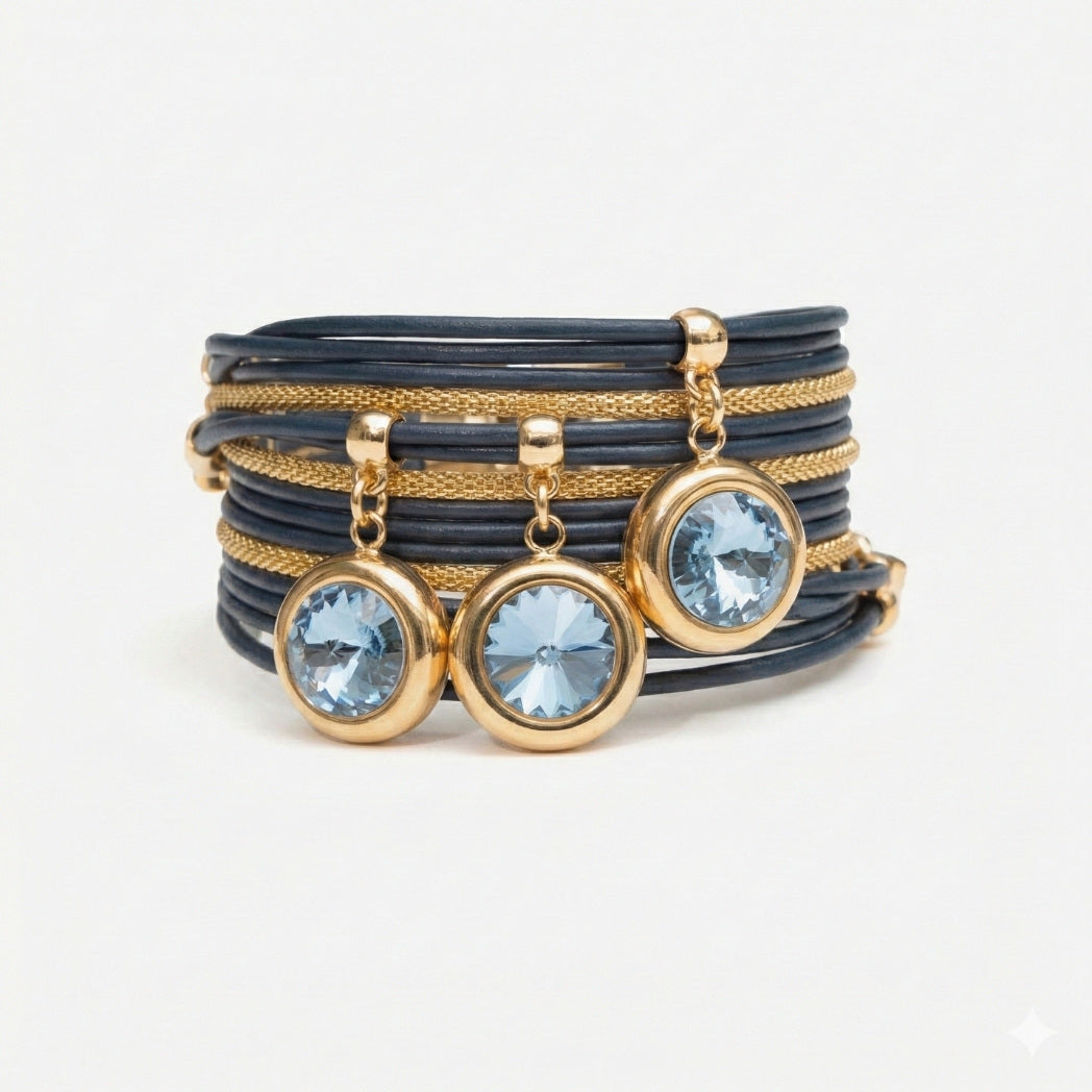 Set of bracelets with blue gemstones and gold accents on a light gray background
