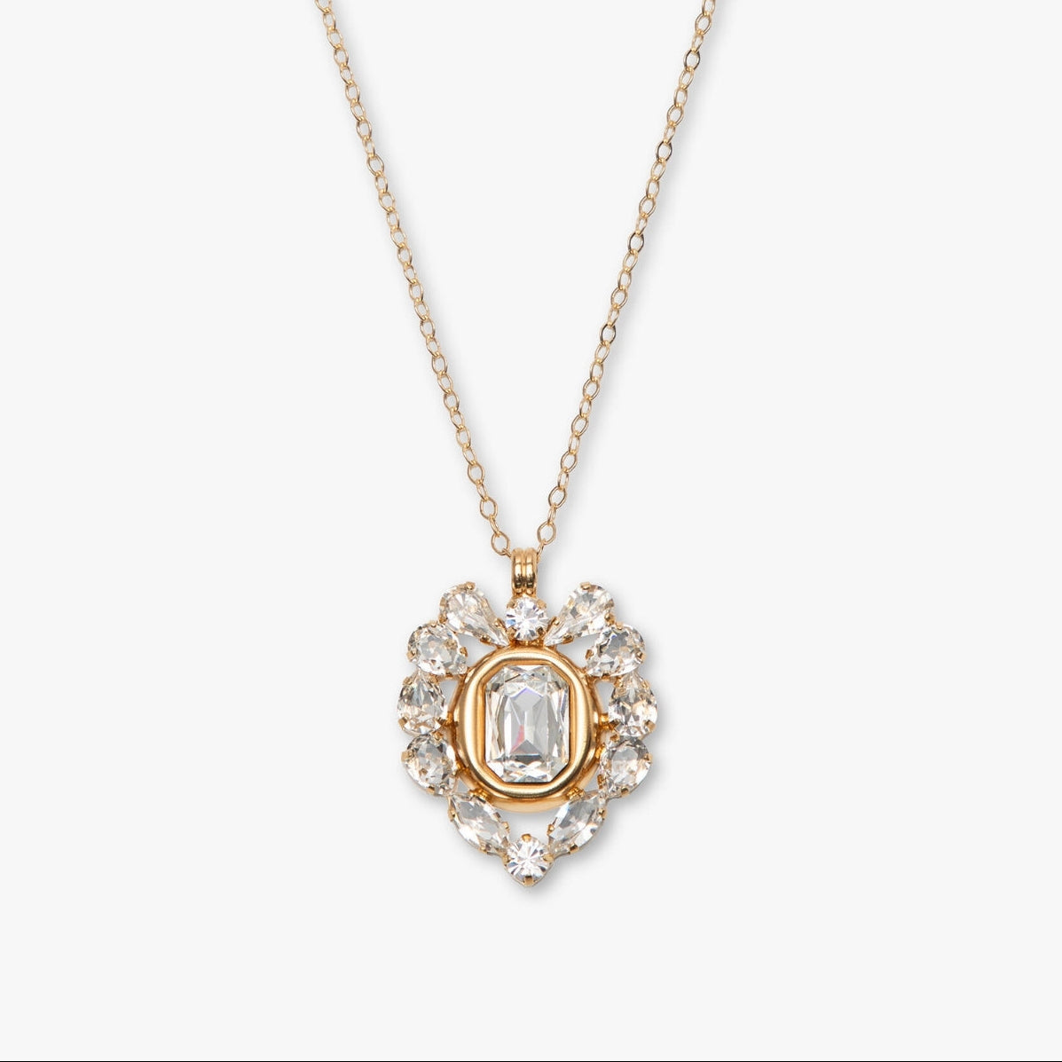Gold necklace with a heart-shaped diamond pendant on a white background